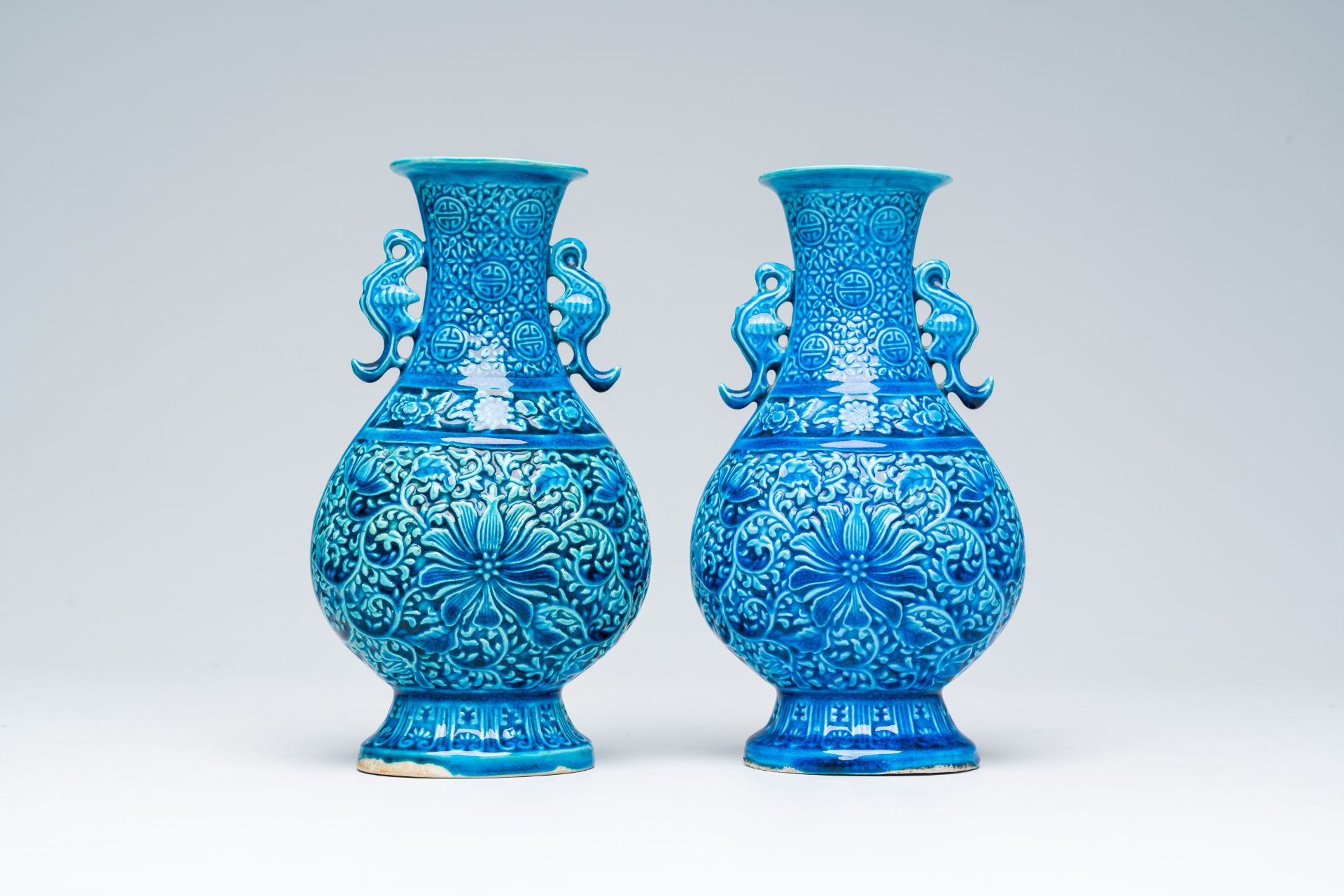 A pair of Chinese turquoise glazed 'lotus' vases, Republic, 20th C.