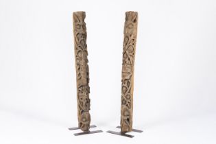 Two Norman carved oak columns with floral design and a coat of arms, possibly used as doorposts, med