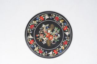 A large round Italian pietra dura table top with floral design, 20th C.