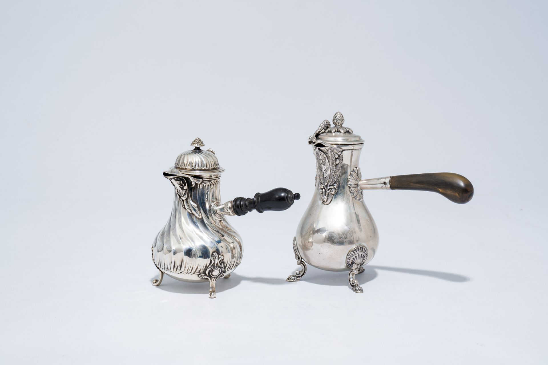 Two silver Louis XV and Louis XVI style 'egoist' jugs and covers, 800 and 950/000, 19th/20th C.