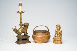 A Chinese gilt bronze Buddha, an engraved paktong handwarmer and a candle holder, 19th C.