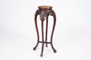 A Chinese open worked carved wood stand with marble top, 20th C.