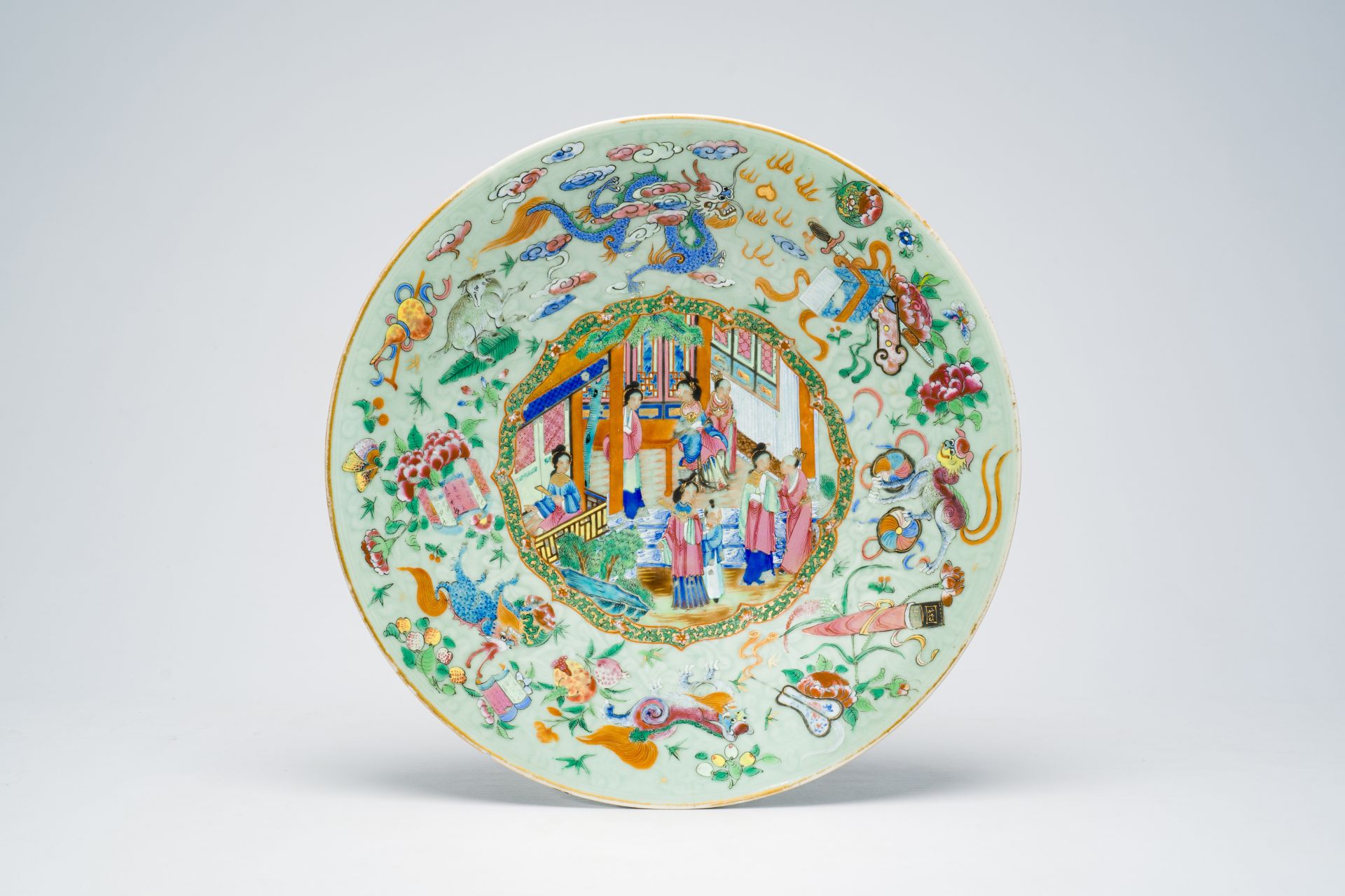 A Chinese Canton famille rose celadon ground dish with underglaze design, a palace scene and mytholo