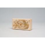 A rectangular Japanese ivory box and cover with a basso relivo fight between a lion and a tiger, Mei