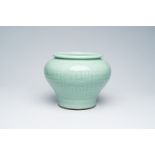 A Chinese celadon jar with underglaze design, Qianlong mark, 19th/20th C.