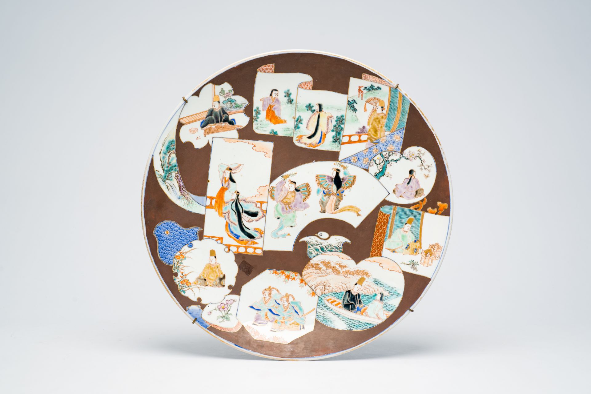 A Japanese Imari dish with figures in a landscape, Meiji, 19th C.