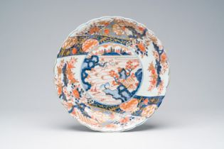 A Japanese Imari dish with a landscape and floral design, Edo, 17th/18th C.