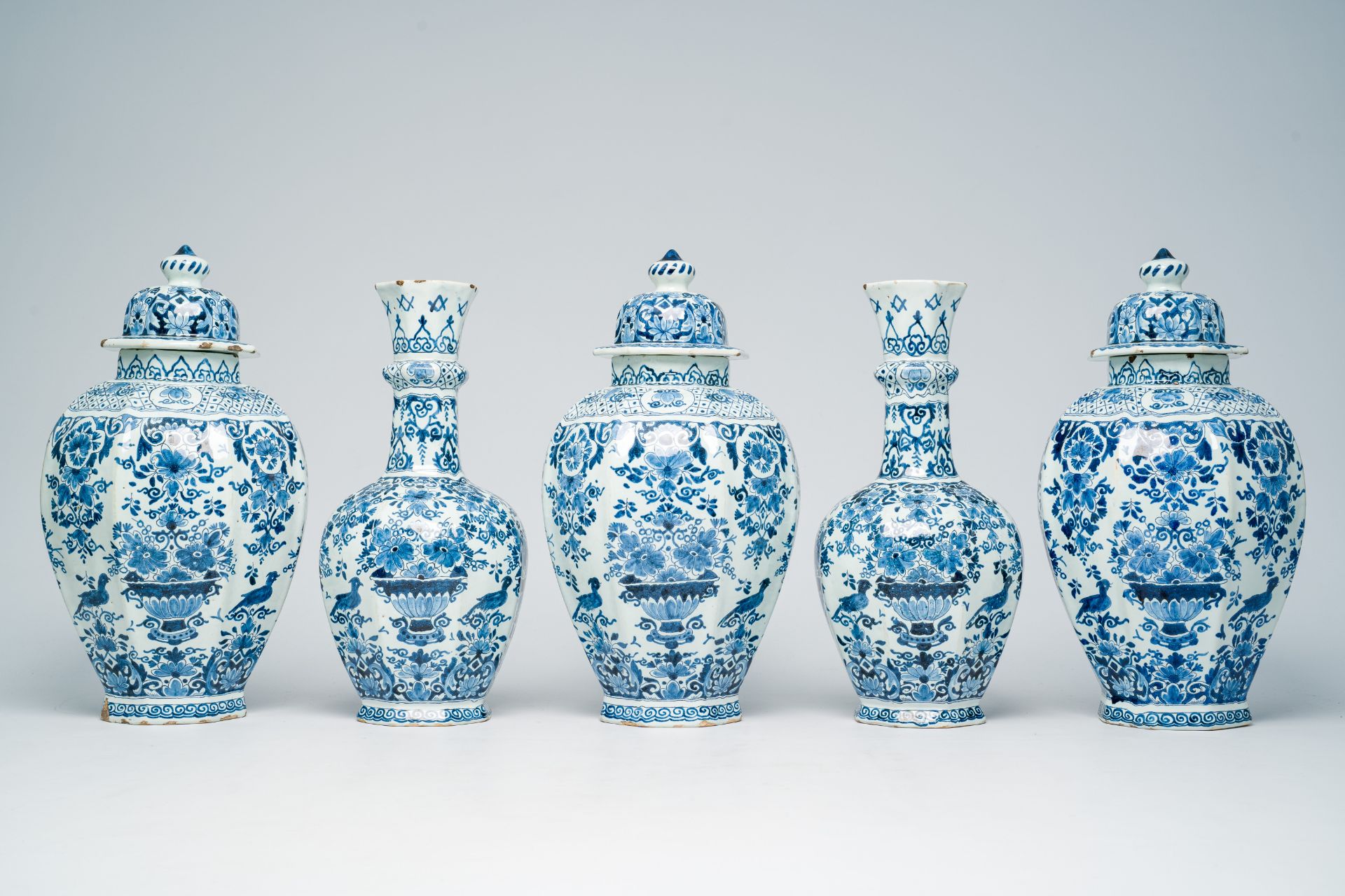 A Dutch Delft blue and white five-piece vase garniture with flower baskets and birds among blossomin - Image 3 of 8