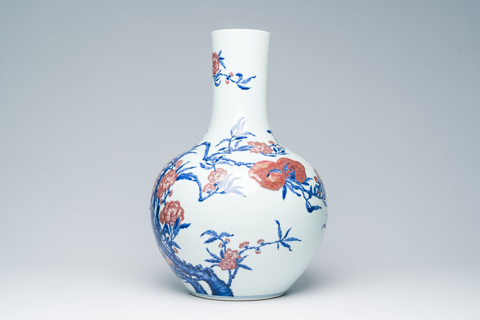 A Chinese blue, white and copper-red 'nine peaches' tianqu ping vase, Qianlong mark, 20th C. - Image 2 of 6
