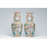 A pair of Chinese Canton famille rose vases with palace scenes, floral design and Buddhist symbols,