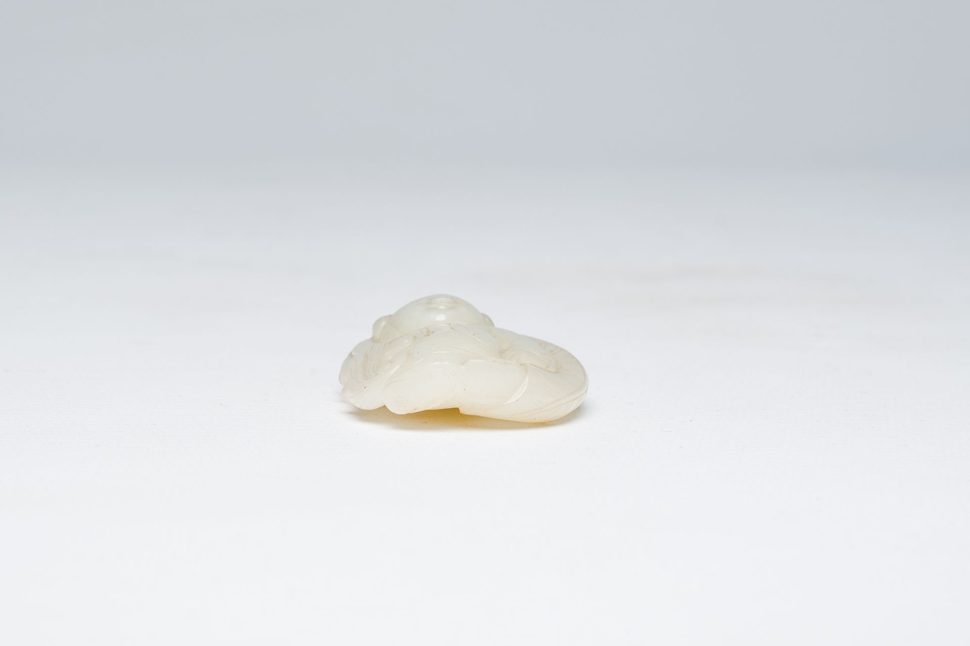 A Chinese white jade pendant with a boy, Qing - Image 6 of 6