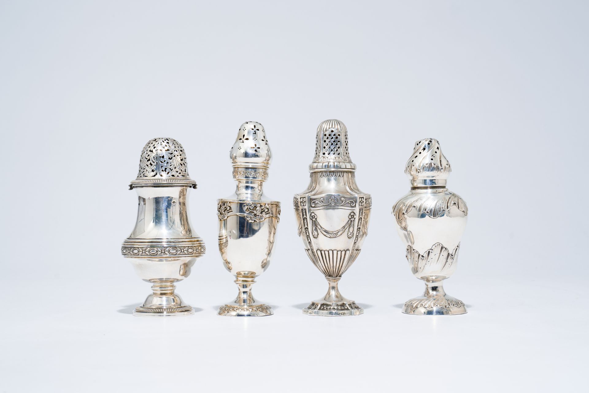 Four various French silver casters with floral design, possibly 18th C. and later