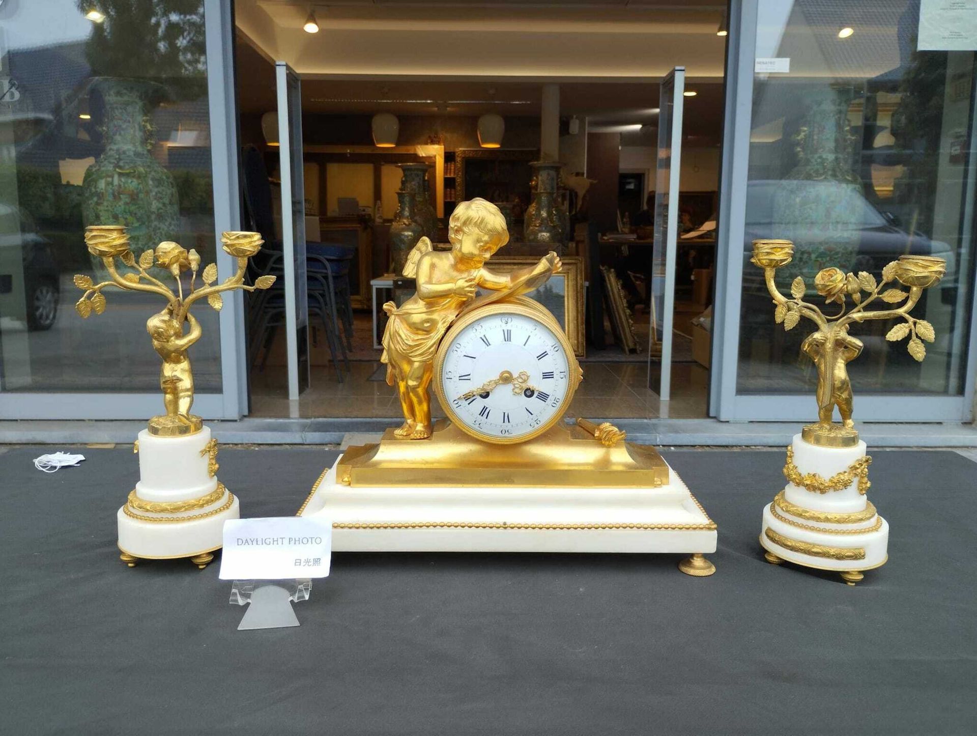 A French gilt bronze mounted white marble three-piece clock garniture with putti, 19th C. - Image 9 of 33