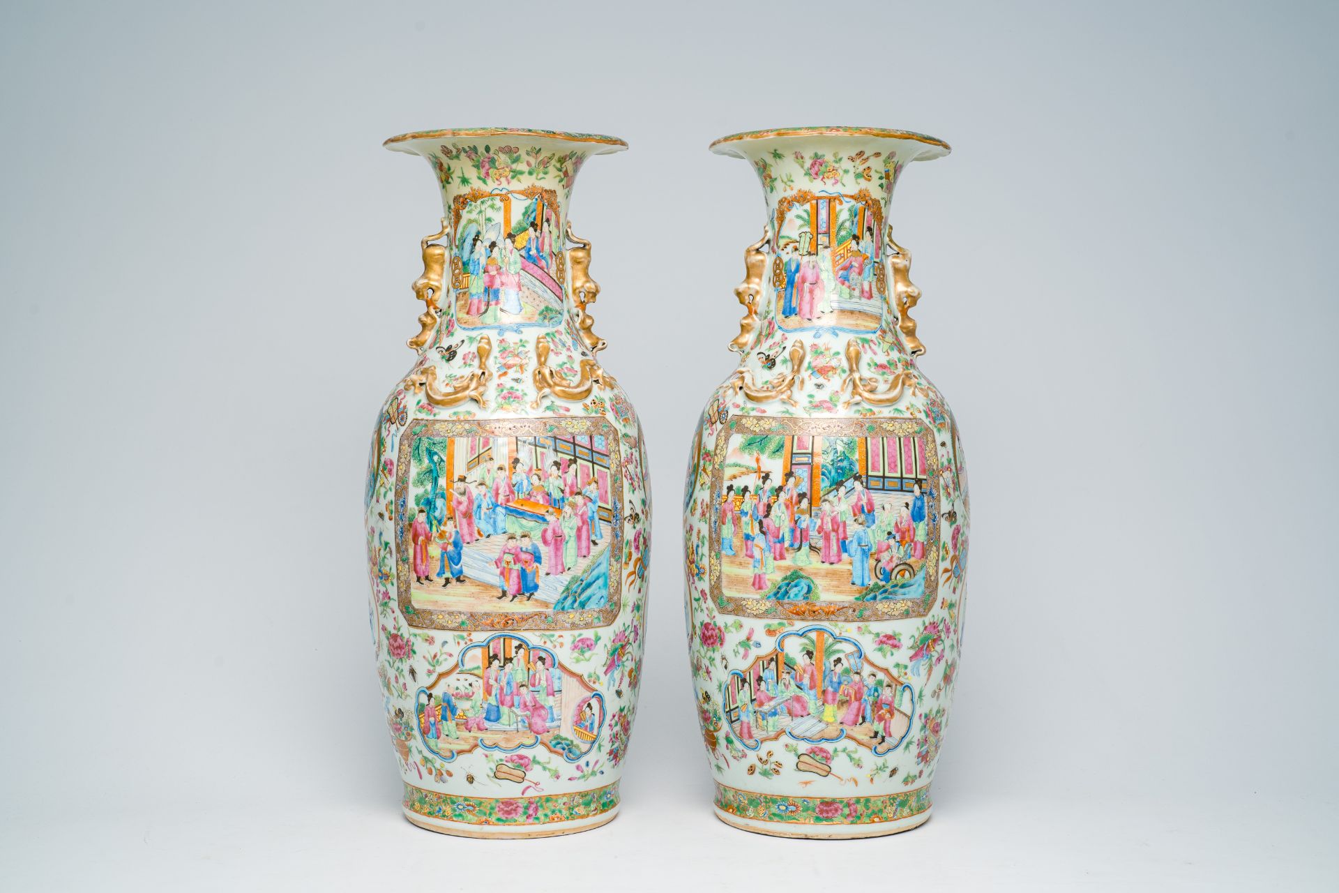 A pair of Chinese Canton famille rose vases with palace scenes and floral design, 19th C.