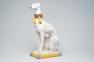 An Italian polychrome glazed terracotta model of a greyhound on a cushion, 20th C.