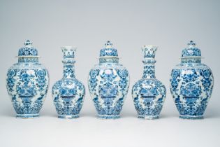 A Dutch Delft blue and white five-piece vase garniture with flower baskets and birds among blossomin