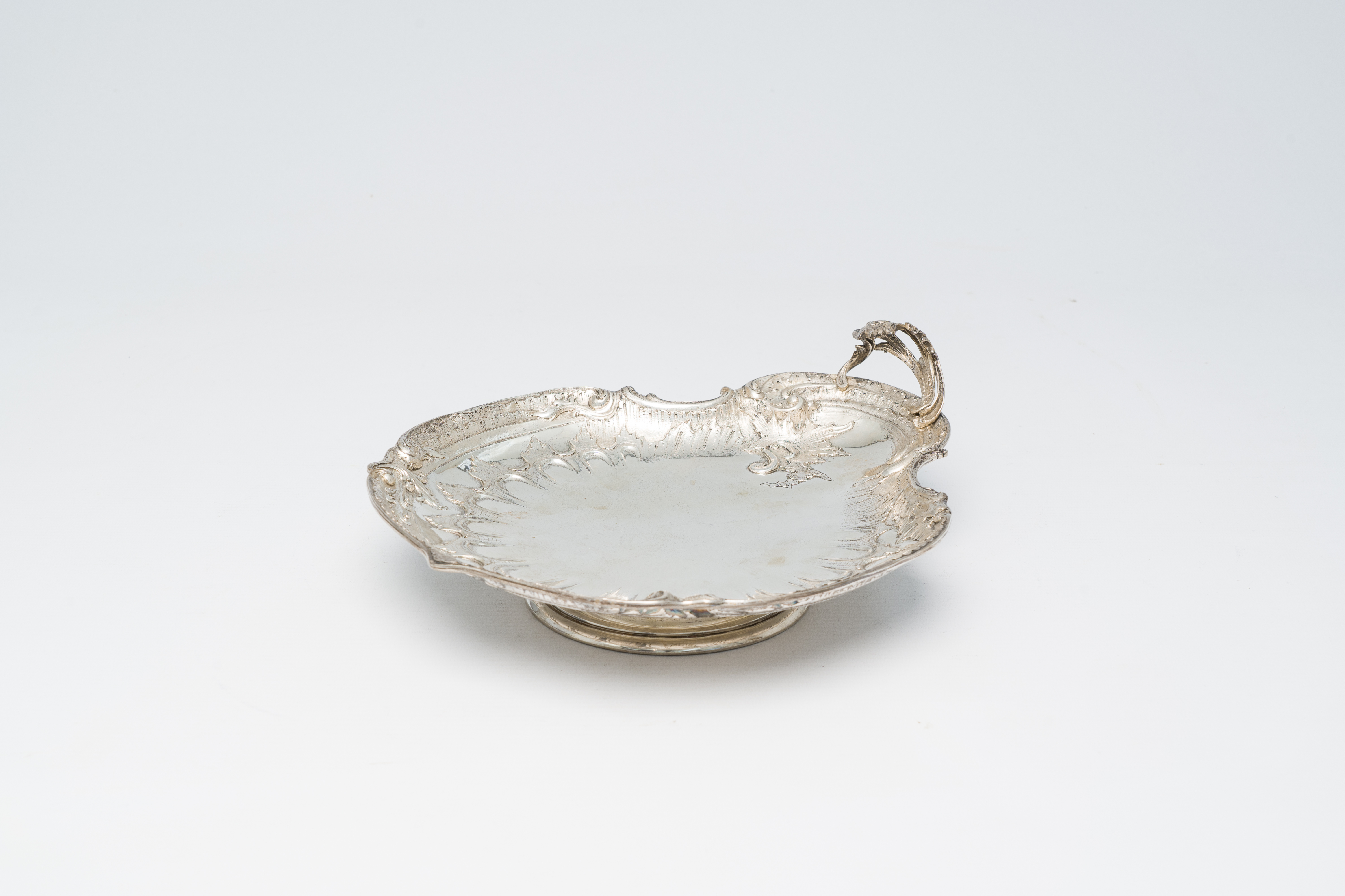 A Belgian shell-shaped silver Louis XV style dish on foot, maker's mark Wolfers, 800/000, Brussels,