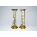 A pair of Chinese Canton famille rose gilt bronze mounted sleeve vases with palace scenes, 19th C.