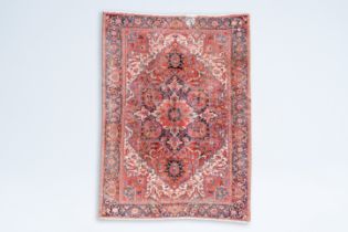 A Persian Heriz rug with floral design, wool on cotton, 20th C.