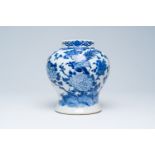 A Chinese crackle glazed blue and white vase with a bird among blossoming branches, 19th C.