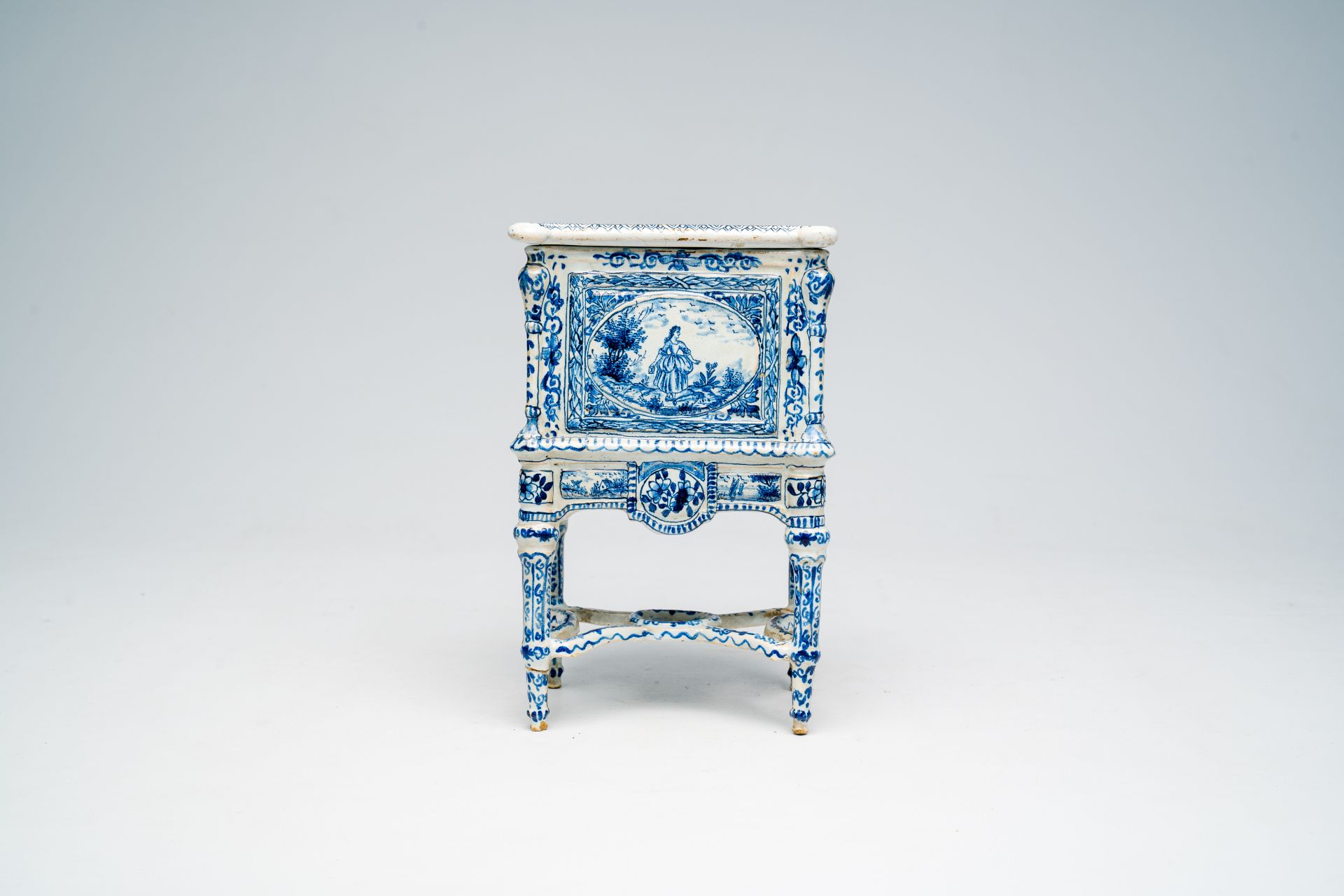 A French blue and white earthenware cabinet on stand with figures in a landscape and floral design, - Image 4 of 7