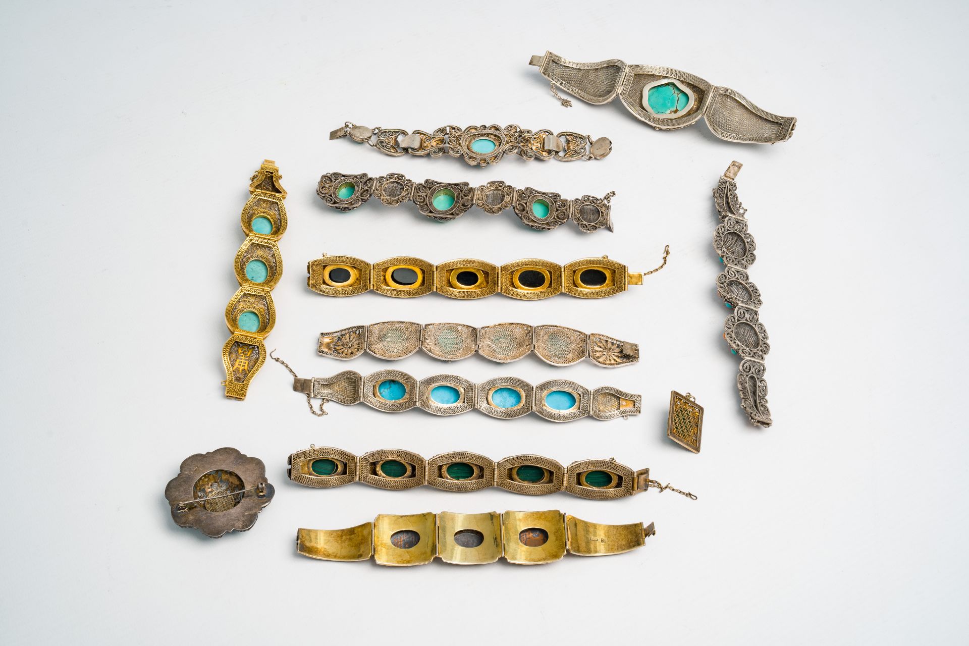 Ten mostly Chinese partly gilt and hardstone-inlaid silver bracelets, a pendant and a brooch, 19th/2 - Image 2 of 10