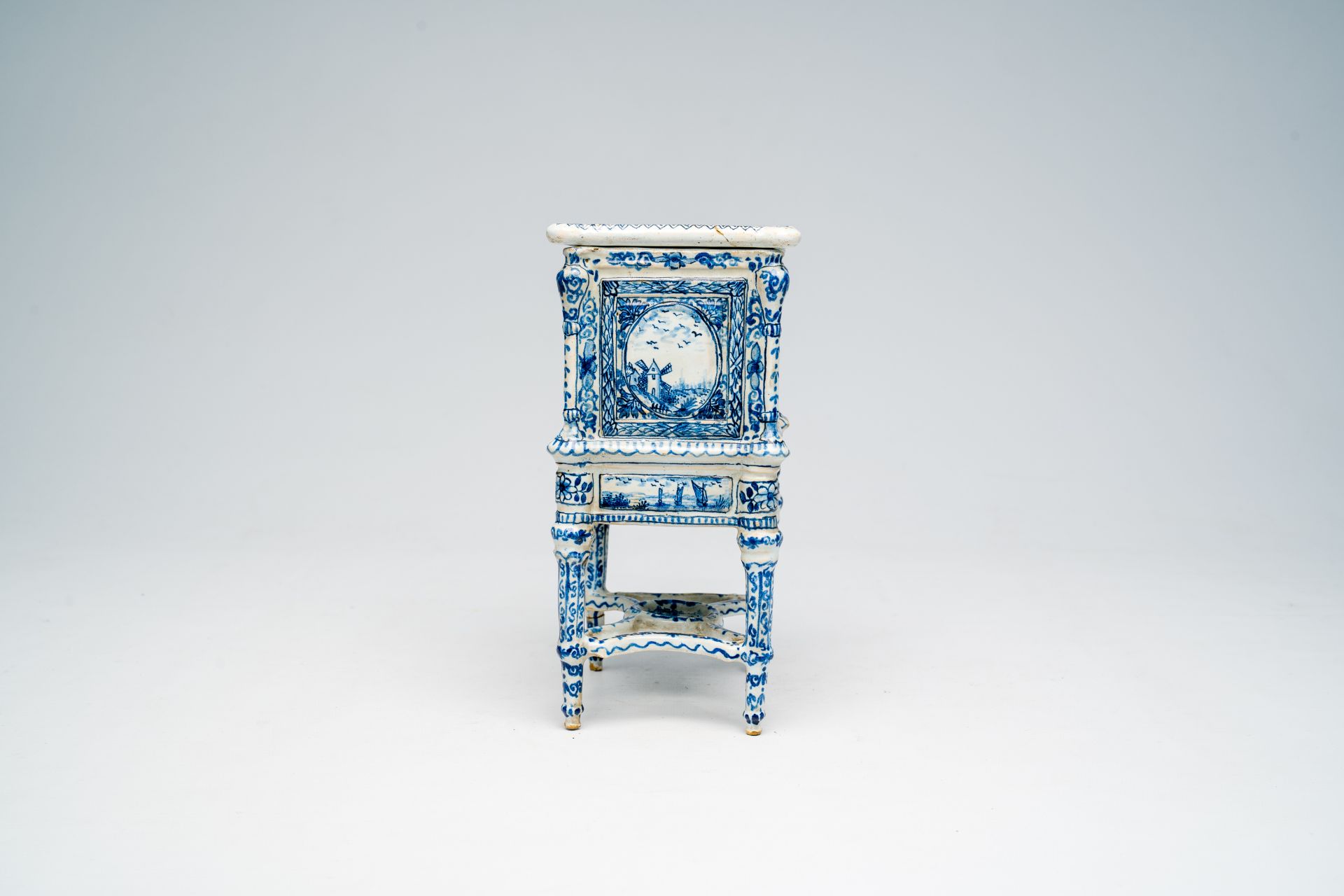 A French blue and white earthenware cabinet on stand with figures in a landscape and floral design, - Image 5 of 7
