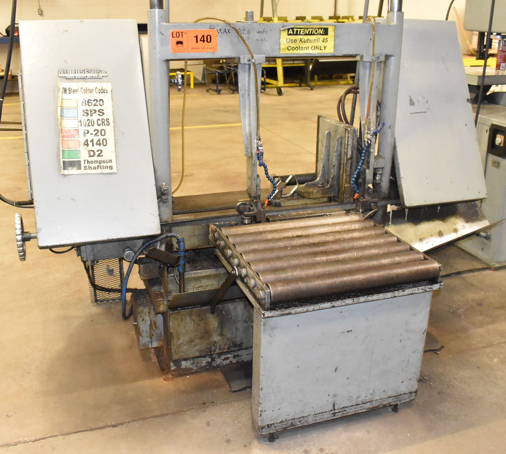 W.F. WELLS & SONS INC. HORIZONTAL BANDSAW WITH MANUAL CLAMPING, COOLANT, IN-FEED CONVEYOR, S/N N/