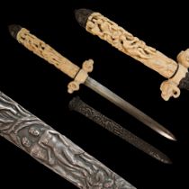 A fine French dagger with carved bone hilt and silver scabbard with erotic scenes, 19th century.