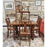 A twentieth century mahogany extending dining table together with five similar dining chairs, one of