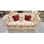 Knole drop-end sofa by Brights of Nettlebed, upholstered in a floral scrolling fabric on a cream