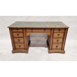 20th century oak pedestal desk with an arrangement of seven drawers around the kneehole, on