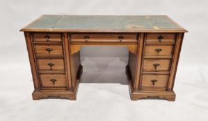 20th century oak pedestal desk with an arrangement of seven drawers around the kneehole, on