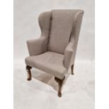 Grey upholstered wingback armchair with red upholstered seat