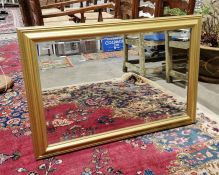 Modern gilt framed wall mirror of rectangular form with bevelled edged glass, 100cm long x 69cm high