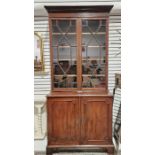 Mahogany library bookcase, the top glazed section with four adjustable shelves, the base with two