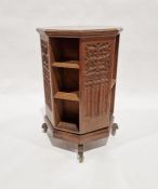 Early 20th century carved oak revolving bookcase of octagonal form, the four-side panels adourned