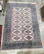 Modern cream ground rug with two rows of seven lozenges on cross divided field, multiple geometric