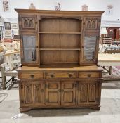 Oak kitchen dresser, the top section with two shelves flanked by single door glazed cupboard and