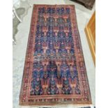 North East Persian blue ground Meshed Belouch rug with repeating geometric and stylized animal