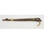 Rosewood-effect walking stick with gilt metal collar, two African carved figure walking sticks,