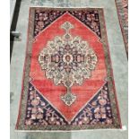 North West Persian red ground Lillihan rug with central floral medallion and floral spandrels,