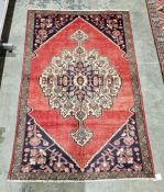 North West Persian red ground Lillihan rug with central floral medallion and floral spandrels,