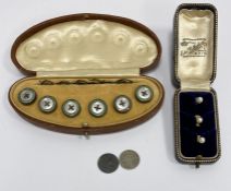 Three gold and pearl studs, cased, 3g approx. and a set of six gilt metal and enamel collar studs,