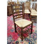Set of 10 early 20th century oak ladderback rush seated dining chairs comprising eight standards and