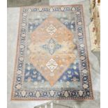 Modern Ghali rust ground carpet with central floral diamond enclosed by four floral lozenges on
