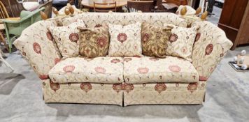 Knole drop-end sofa by Brights of Nettlebed, upholstered in a floral scrolling fabric on a cream