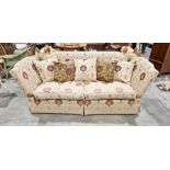 Knole drop-end sofa by Brights of Nettlebed, upholstered in a floral scrolling fabric on a cream