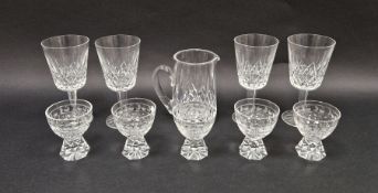 Set of four Waterford cut glass wines, a Waterford cut glass jug and a set of five cut glass