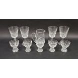 Set of four Waterford cut glass wines, a Waterford cut glass jug and a set of five cut glass